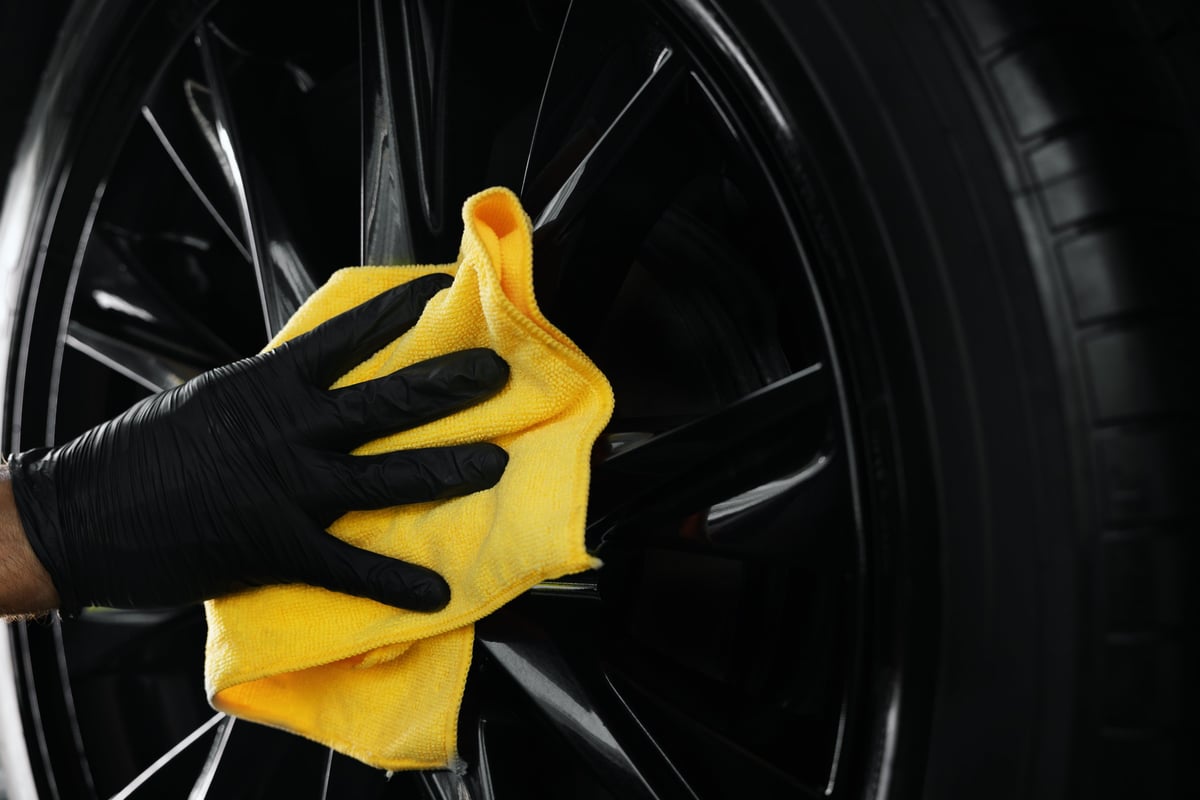 Car detailing professional cleaning alloy wheel with microfiber cloth