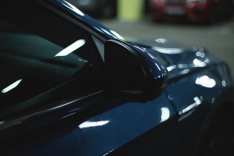 Glossy smooth car paint surface showroom finish after clay bar treatment
